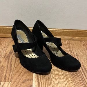 Round toed black suede heels with strap.